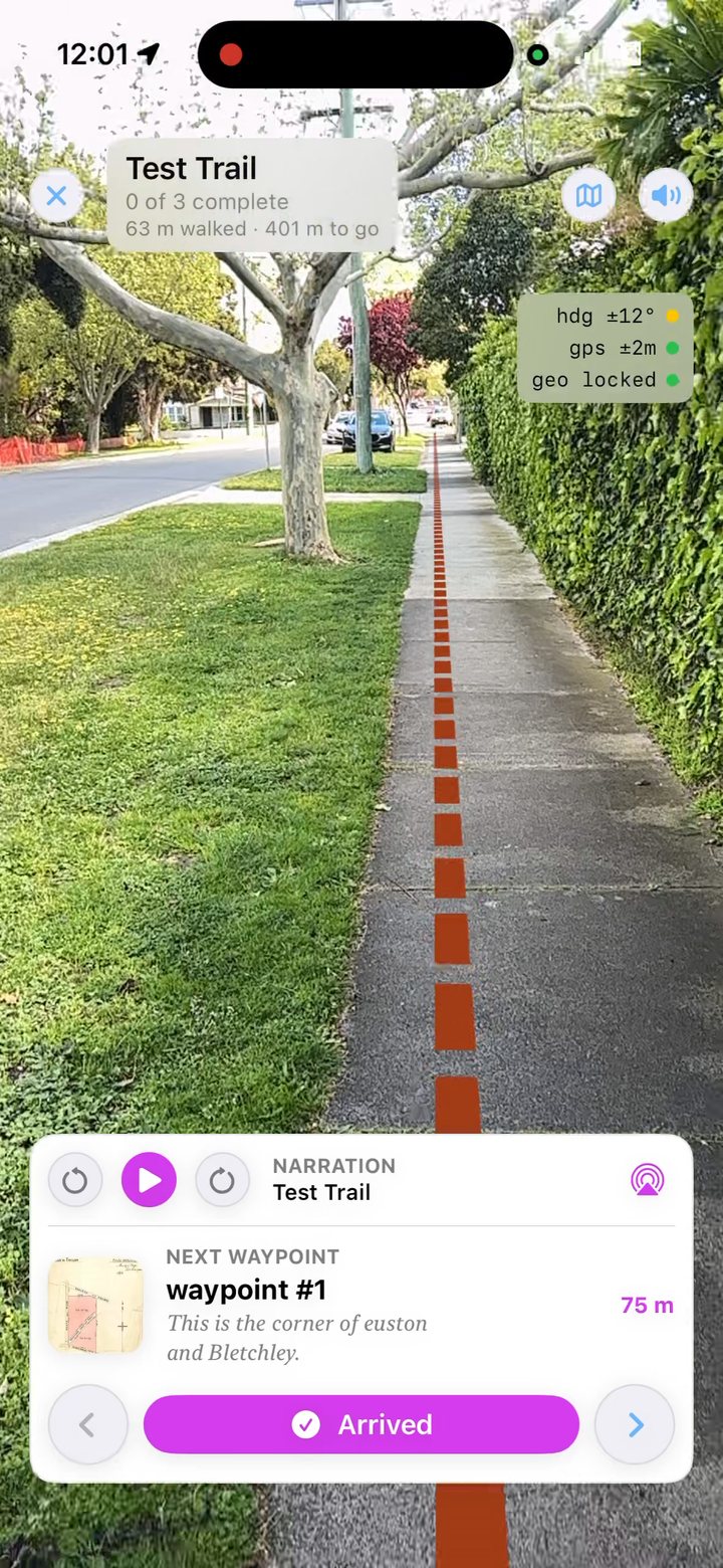 AR view on iPhone: a dashed clay-coloured line running straight down the middle of a footpath between a lawn and a hedge, with the status lights at the top right.
